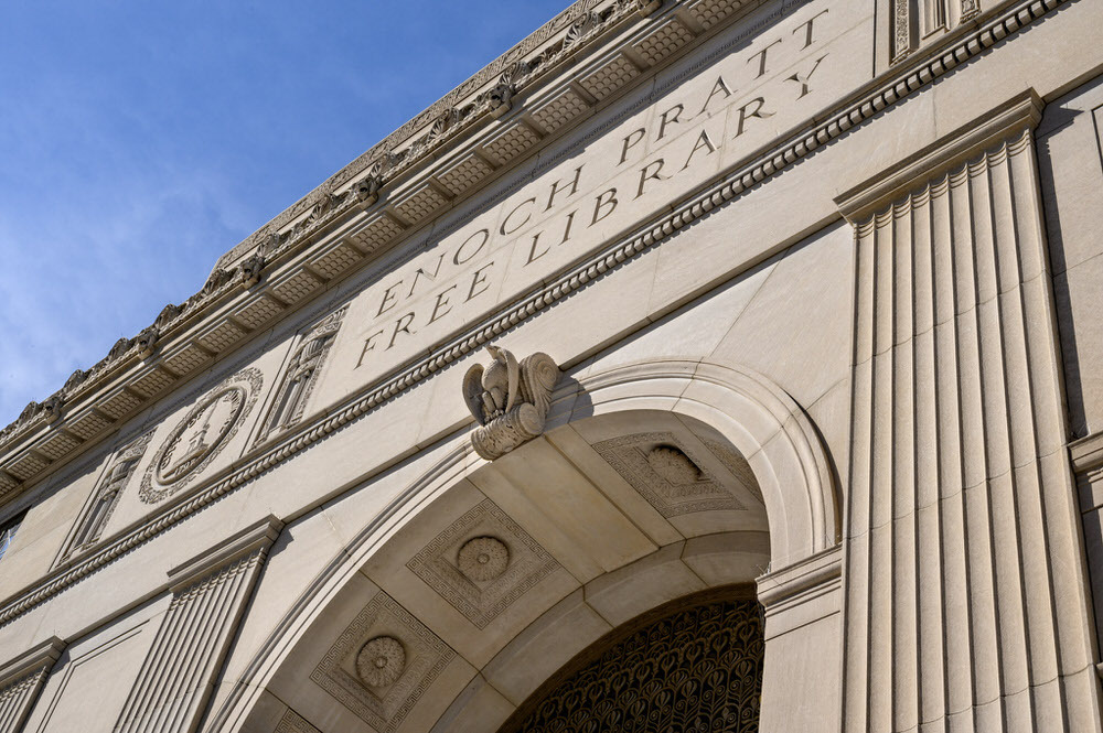 Pratt Library Central arch against a blue sky