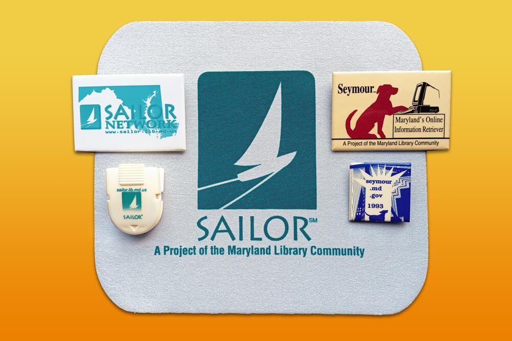 Sailor and Seymour history ephemera - a mousepad, clip, and  pins with logs and slogans
