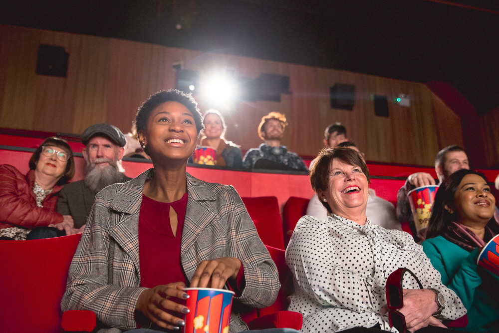 audience members at a public performance of a movie screening