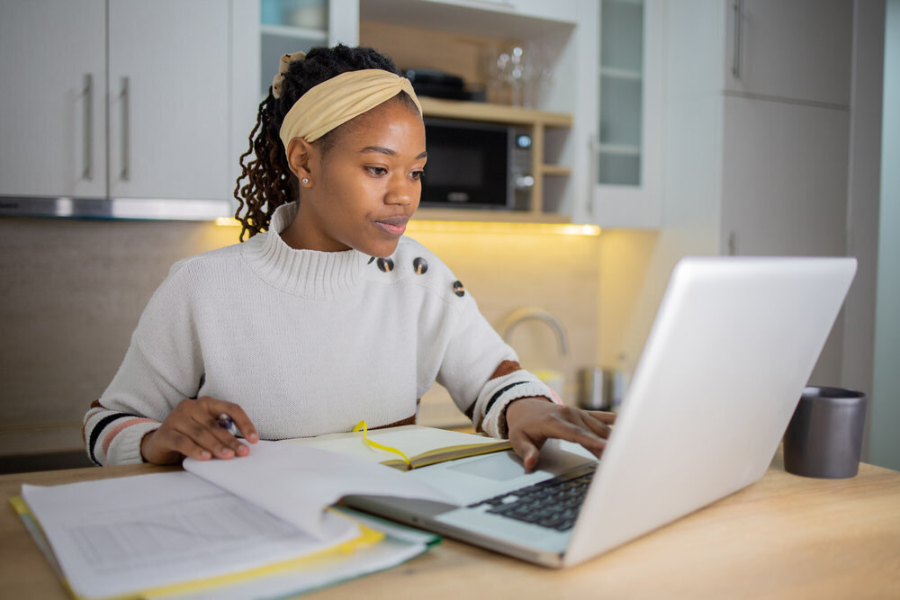 a woman doing research at home with a laptop